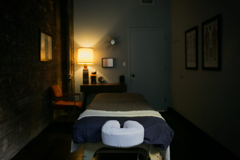 Large massage therapy treatment room at Bodyworks DW in NYC designed for therapist comfort and client care.